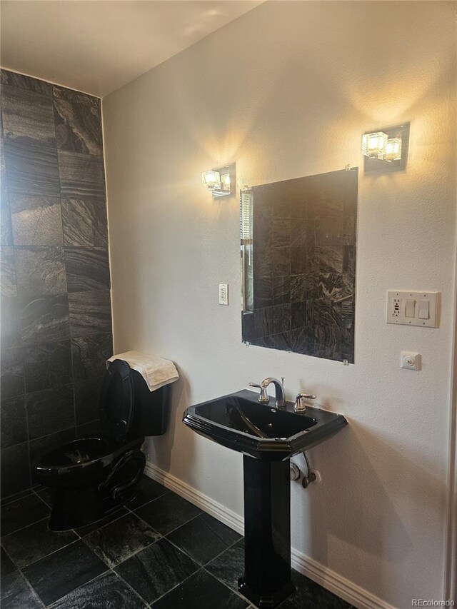 bathroom featuring tile patterned flooring and toilet