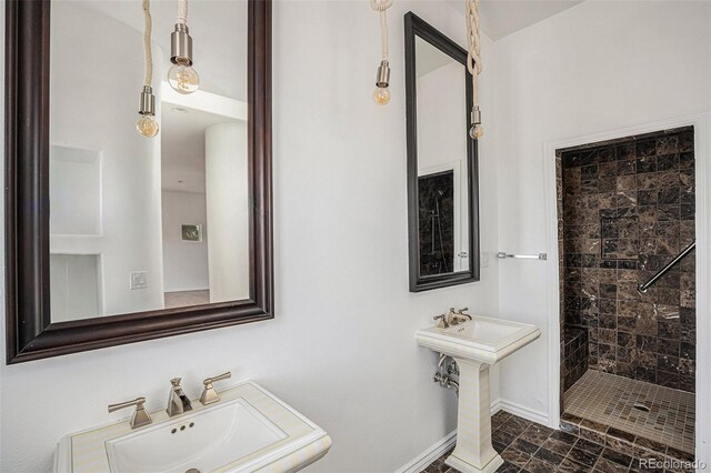 bathroom featuring sink, tile patterned flooring, and tiled shower