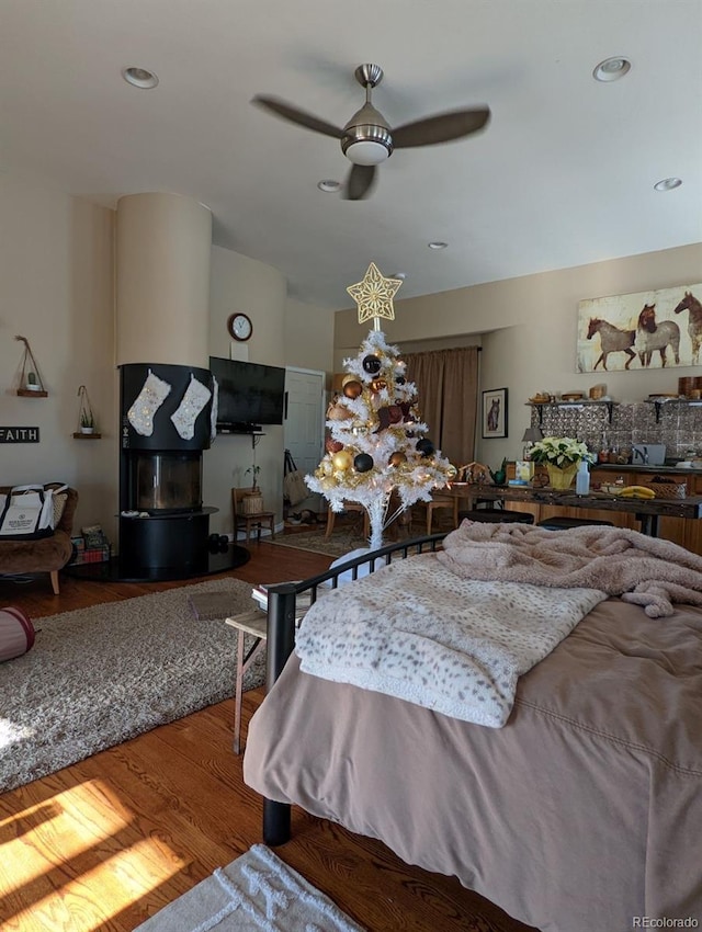 bedroom featuring ceiling fan, wood finished floors, and recessed lighting