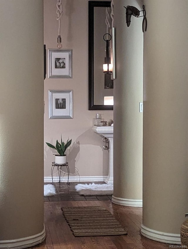 bathroom with baseboards and wood finished floors