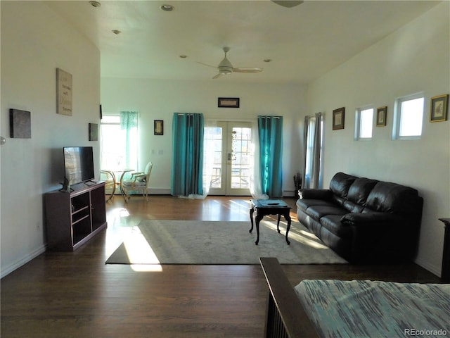 living area with dark wood-style floors, ceiling fan, french doors, and baseboards