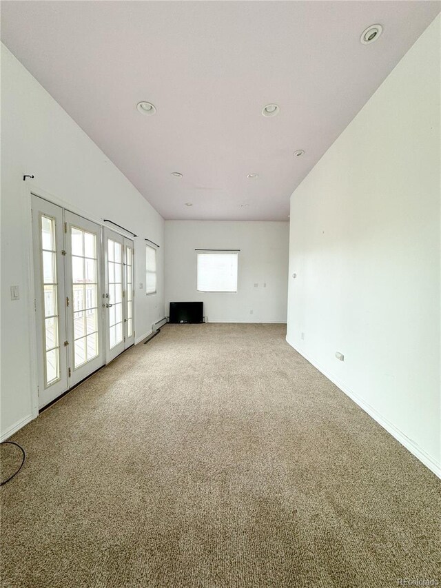 carpeted spare room with french doors