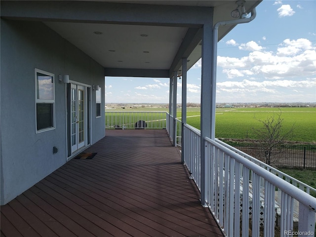 wooden terrace featuring a rural view