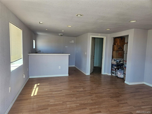 spare room featuring a textured ceiling and hardwood / wood-style flooring