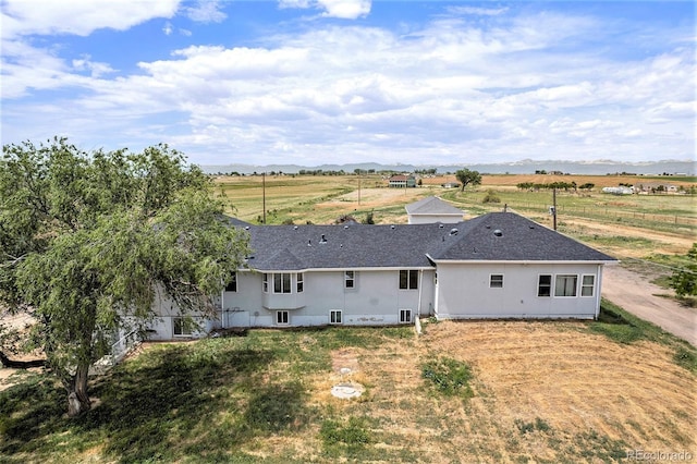 birds eye view of property with a rural view