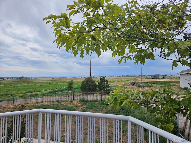 view of yard featuring a balcony and a rural view