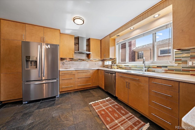 kitchen featuring decorative backsplash, a sink, light countertops, stainless steel appliances, and wall chimney exhaust hood