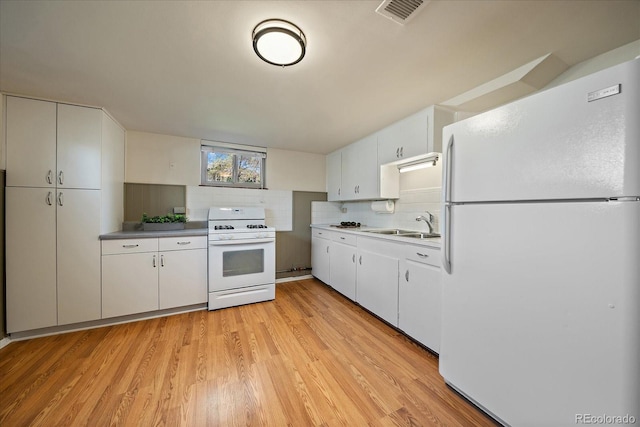 kitchen featuring backsplash, visible vents, white cabinets, white appliances, and light wood-style flooring