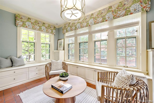 living area with crown molding and a notable chandelier