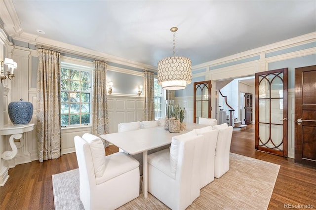 dining room featuring hardwood / wood-style flooring and ornamental molding