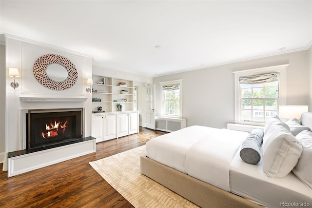 bedroom with dark wood-type flooring, crown molding, and radiator