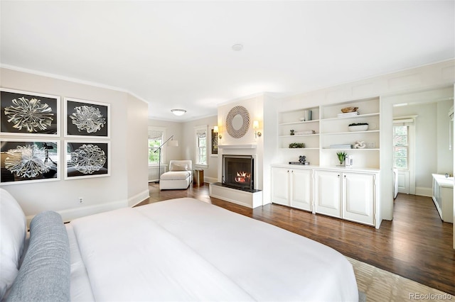 bedroom with ornamental molding and dark hardwood / wood-style floors