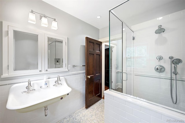 bathroom featuring sink, tile walls, and an enclosed shower