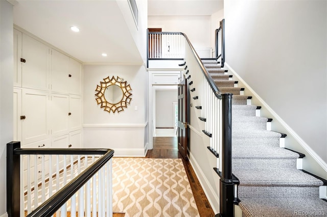 staircase with hardwood / wood-style flooring