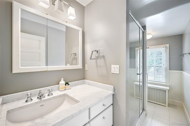 bathroom with tile patterned flooring, vanity, and an enclosed shower