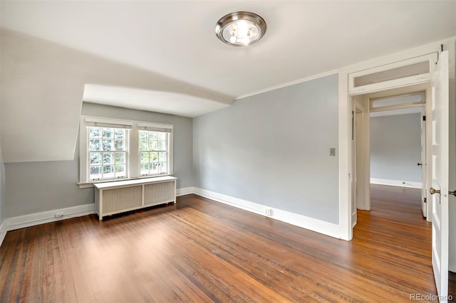 unfurnished room featuring radiator heating unit and wood-type flooring