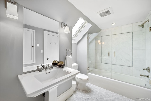 full bathroom with toilet, combined bath / shower with glass door, sink, and a skylight