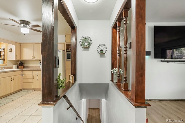 6371 Brooks Dr, Arvada, CO 80004 - hall with an upstairs landing and light tile patterned floors