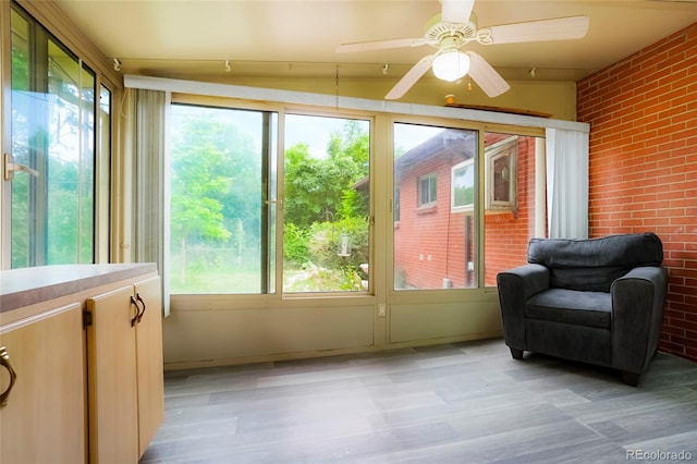 6371 Brooks Dr, Arvada, CO 80004 - sunroom / solarium featuring brick wall and wood finished floors