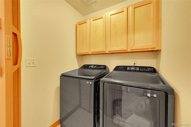 laundry area featuring cabinet space and separate washer and dryer