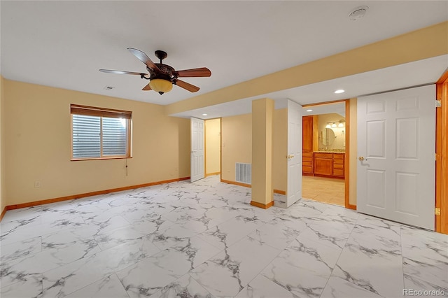 spare room featuring marble finish floor, visible vents, baseboards, and ceiling fan