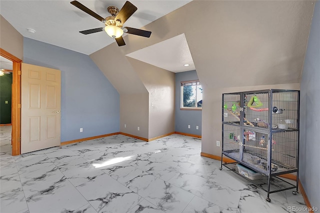 bonus room with vaulted ceiling, marble finish floor, a ceiling fan, and baseboards