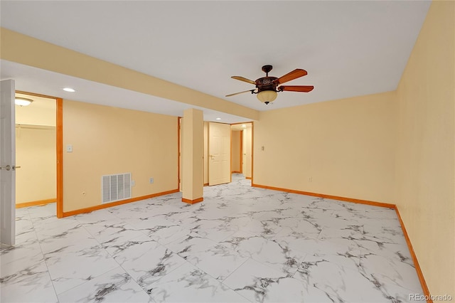 spare room with marble finish floor, recessed lighting, visible vents, and baseboards