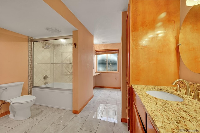 bathroom featuring baseboards, shower / bath combination with glass door, vanity, and toilet