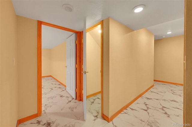 hall with marble finish floor, recessed lighting, and baseboards