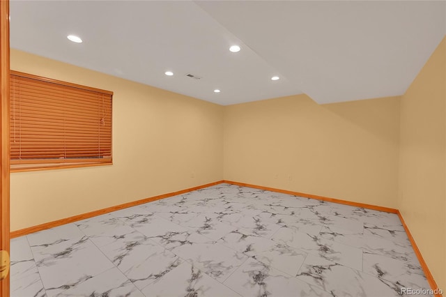 empty room featuring recessed lighting, marble finish floor, visible vents, and baseboards