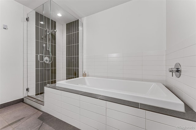 bathroom featuring tile patterned flooring and plus walk in shower