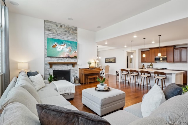 15987 E 115th Pl, Commerce City, CO 80022 - living area with dark wood-type flooring, recessed lighting, and a stone fireplace