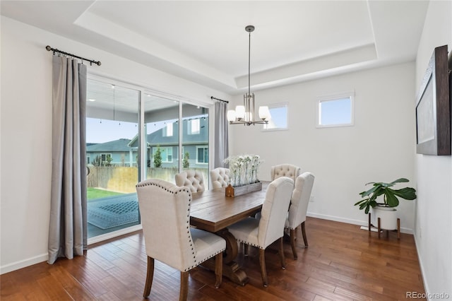 15987 E 115th Pl, Commerce City, CO 80022 - dining room featuring a raised ceiling, a chandelier, dark wood finished floors, and baseboards