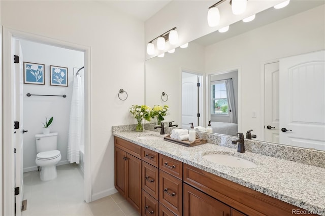 15987 E 115th Pl, Commerce City, CO 80022 - full bathroom with double vanity, toilet, tile patterned floors, baseboards, and shower / bath combo