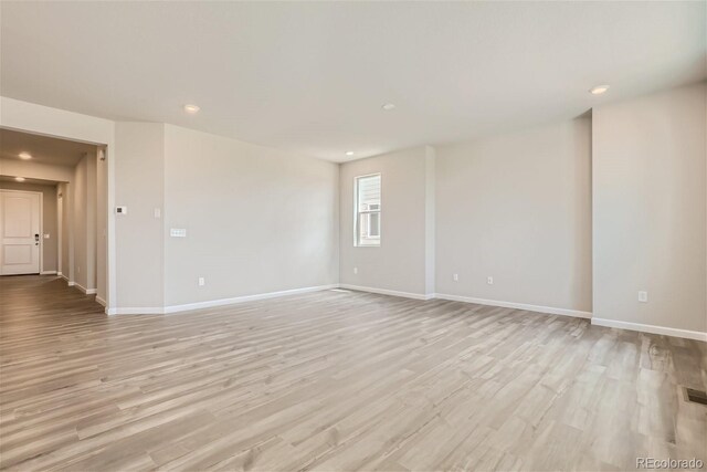 unfurnished room with light wood-type flooring