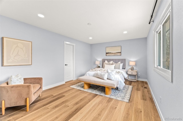 bedroom featuring light wood-style floors, baseboards, and recessed lighting