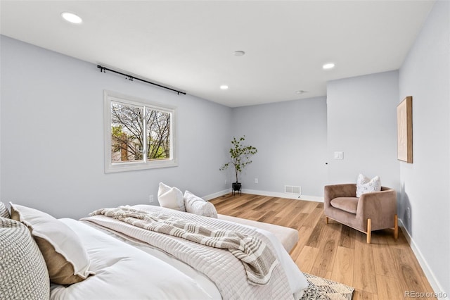 bedroom featuring baseboards, recessed lighting, light wood-style floors, and visible vents