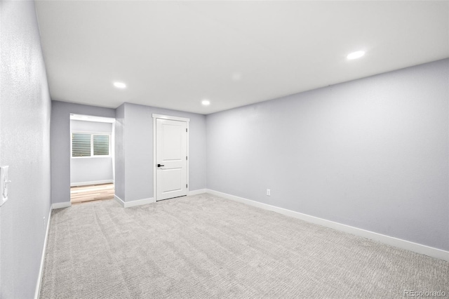 basement featuring carpet flooring, baseboards, and recessed lighting