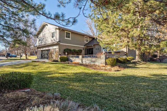 view of front of property featuring a garage and a front yard