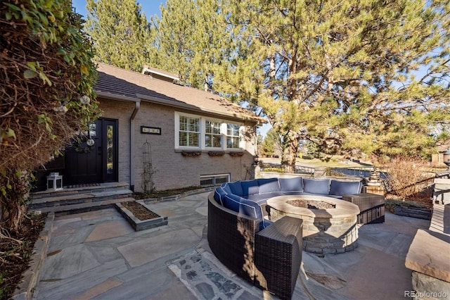 view of patio / terrace featuring an outdoor living space with a fire pit