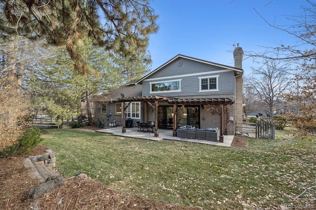 back of house with a pergola, an outdoor hangout area, a lawn, and a patio area