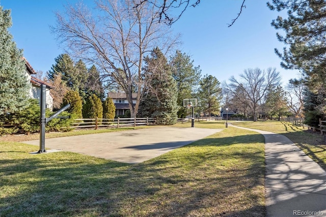 view of property's community with a yard and basketball hoop