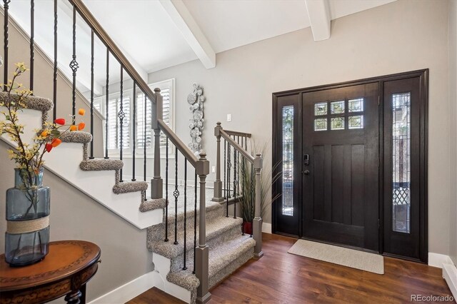 entrance foyer featuring dark hardwood / wood-style floors and beam ceiling