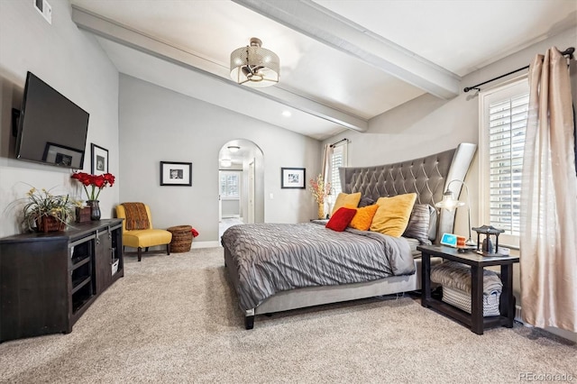 bedroom with carpet flooring and vaulted ceiling with beams