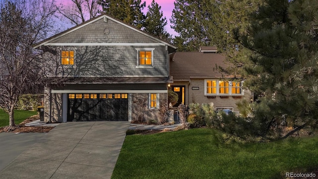 view of front of property featuring driveway, a garage, and a front yard