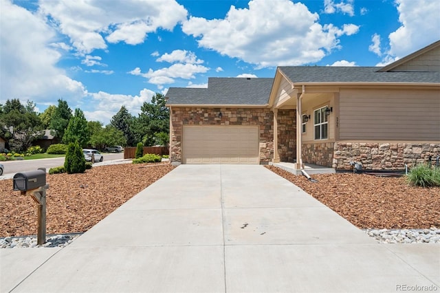 5795 Xenon Way, Arvada, CO 80002 - view of front of property with an attached garage, concrete driveway, stone siding, and a shingled roof