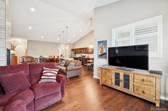 5795 Xenon Way, Arvada, CO 80002 - living room featuring dark wood-style flooring, high vaulted ceiling, and recessed lighting