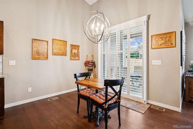 5795 Xenon Way, Arvada, CO 80002 - dining area with a chandelier, healthy amount of natural light, dark wood-style flooring, and a high ceiling