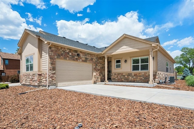 5795 Xenon Way, Arvada, CO 80002 - ranch-style house with stone siding, driveway, and a garage