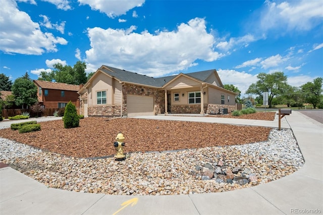 5795 Xenon Way, Arvada, CO 80002 - single story home with stone siding, driveway, and a garage